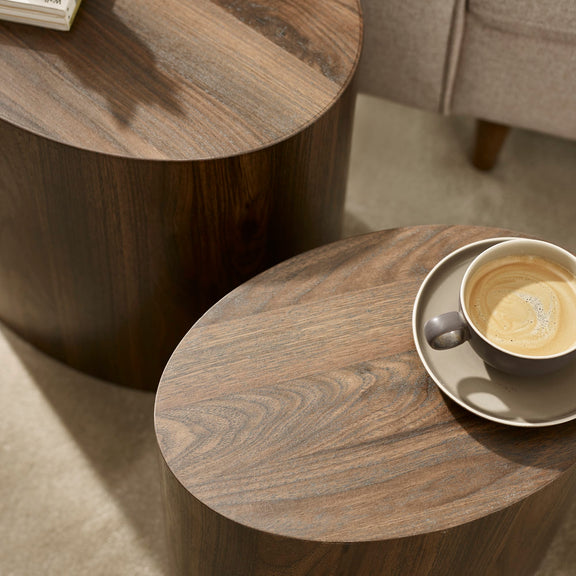 Wooden side table with a cup of coffee on a saucer