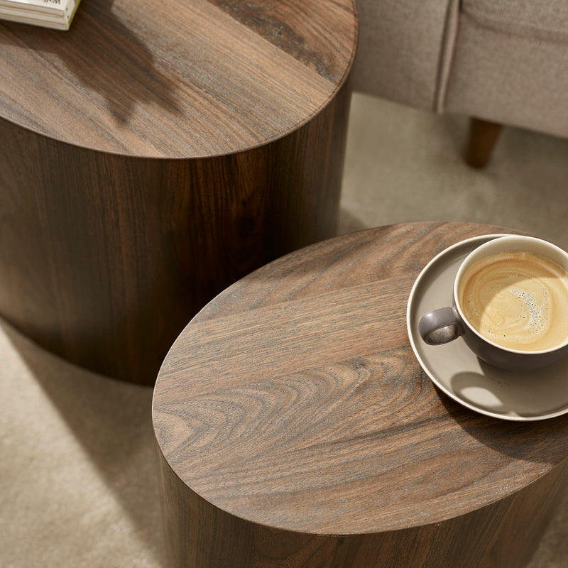 Wooden side table with a cup of coffee on a saucer