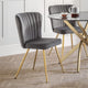Gray upholstered chair with gold legs in a dining setting