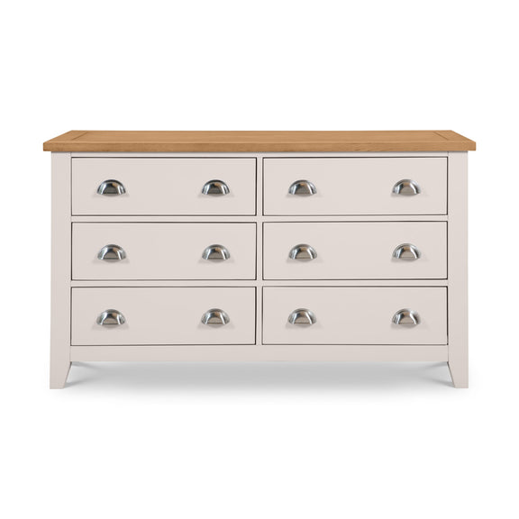 White dresser with six drawers and a wooden top on a white background