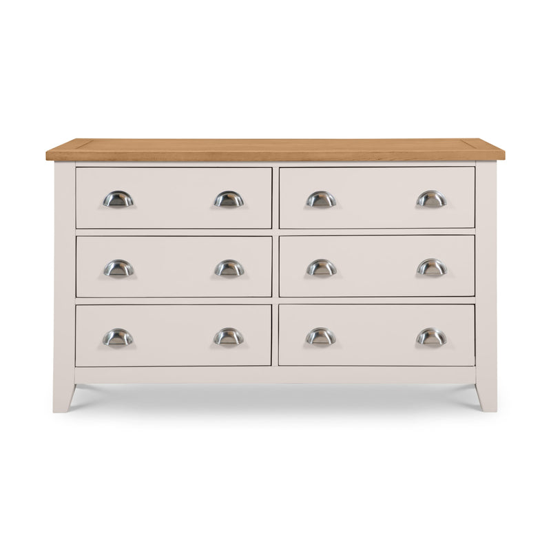 White dresser with six drawers and a wooden top on a white background