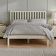 Bedroom with a wooden bed frame, gray bedding, and nightstands.
