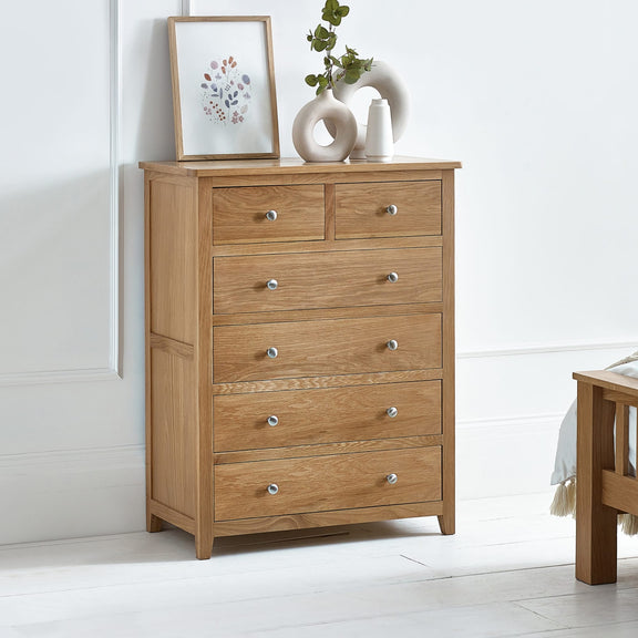 Wooden dresser with multiple drawers in a room setting.
