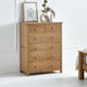 Wooden dresser with multiple drawers in a room setting.