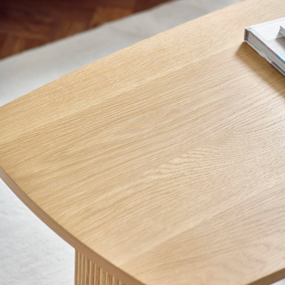 Close-up of a wooden desk surface with a minimal background
