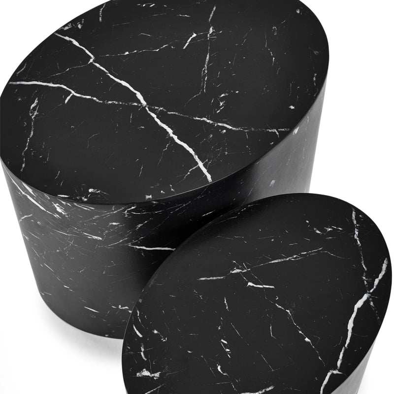Two black marble cylindrical side tables on a white background