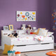 Children's room with a white bed, colorful pillows, and toys against a purple wall.