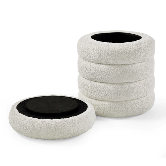 Stack of white textured coasters with black centers on a white background