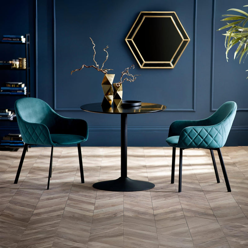 Modern interior with teal chairs and a black table against a blue wall.