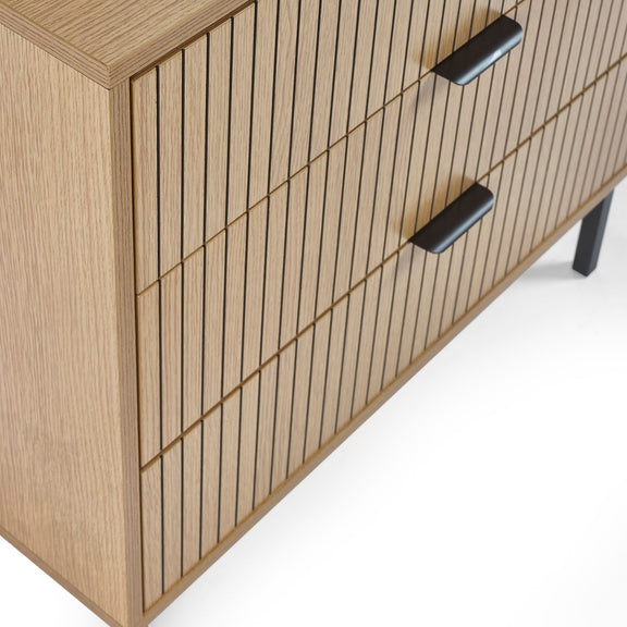 Wooden cabinet with vertical slats and black handles on a white background