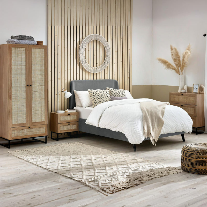 Modern bedroom with wooden wardrobe, bed, and side tables.