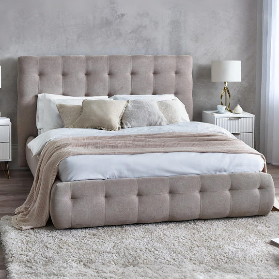 Beige upholstered bed with tufted headboard in a modern bedroom setting.