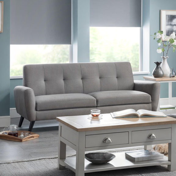 Gray sofa in a living room with a coffee table and decorative items.