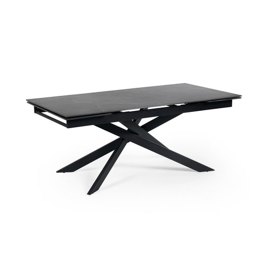 Modern black dining table with unique star-shaped legs on a white background