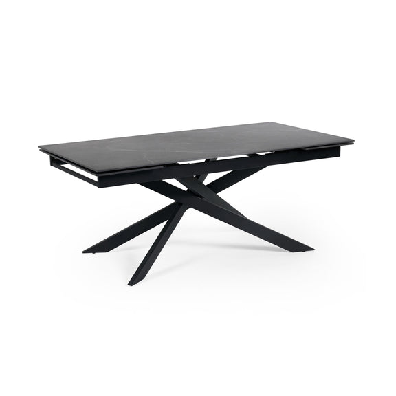 Modern black dining table with unique star-shaped legs on a white background