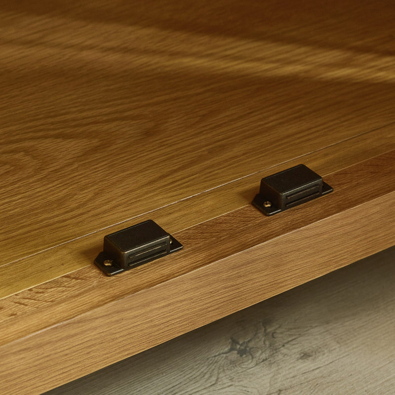 Close-up of wooden furniture with metal brackets on a wooden surface.