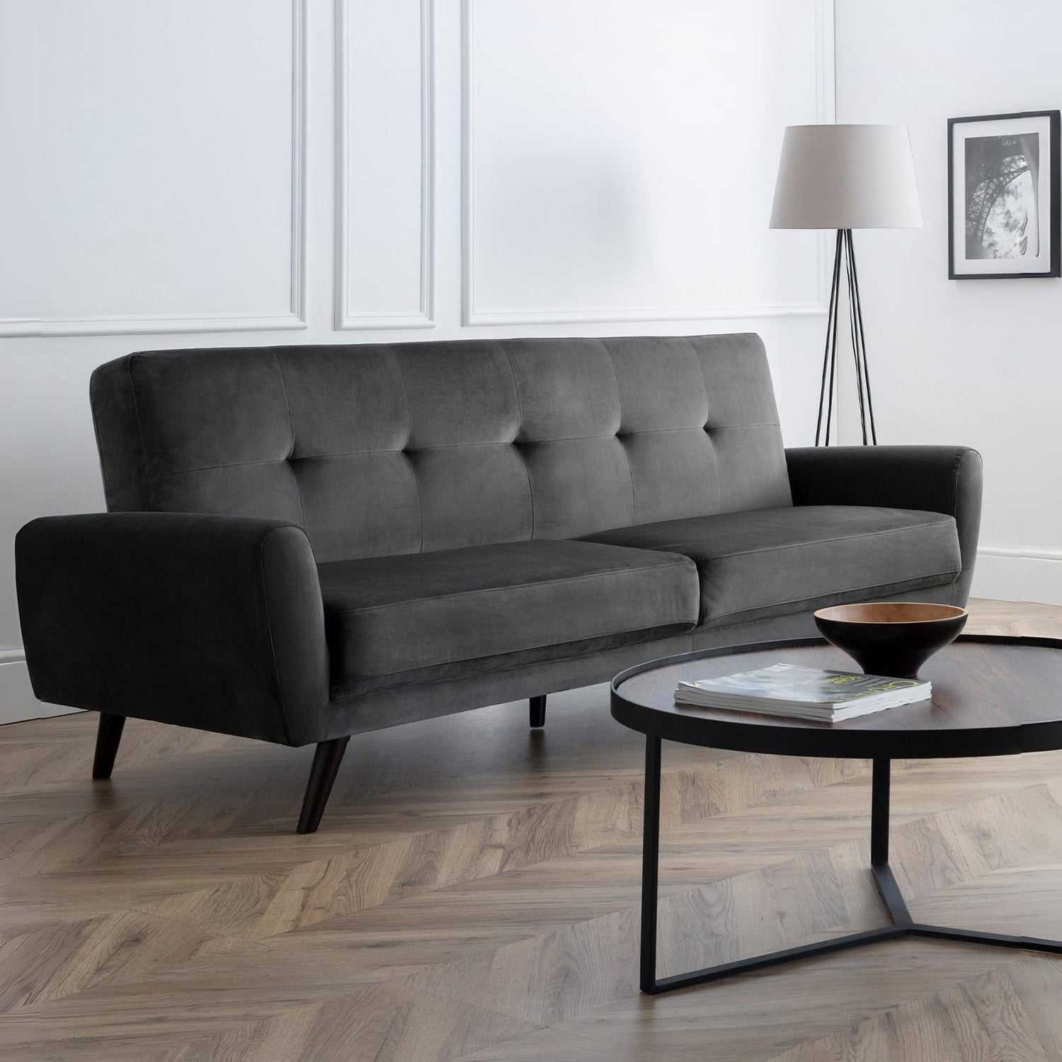 Gray sofa in a modern living room with a coffee table and lamp.