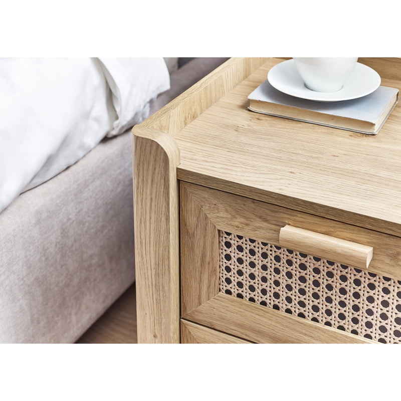 Oak bedside cabinet with drawer open storing books and accessories