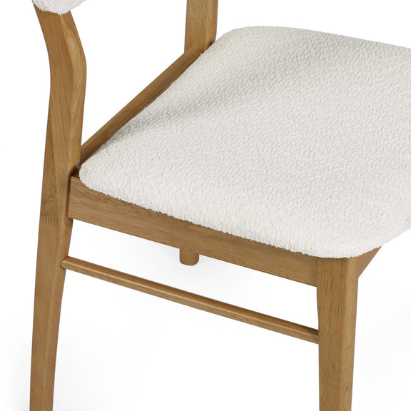 Wooden chair with a white cushioned seat on a white background
