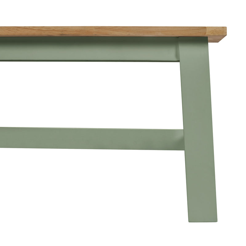 Close-up of a green metal frame with a wooden top on a white background