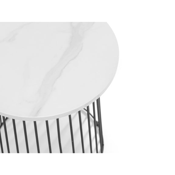 Round white table with black metal base on a white background