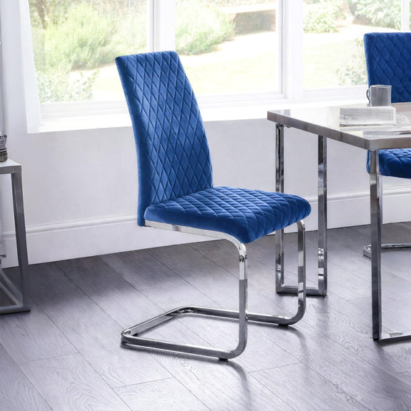 Blue upholstered chair with chrome legs in a modern room setting.