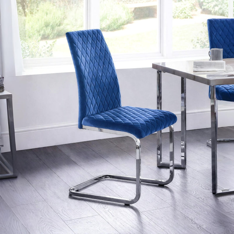 Blue upholstered chair with chrome legs in a modern room setting.