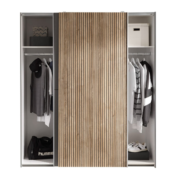 Closet with wooden sliding door and clothes on both sides