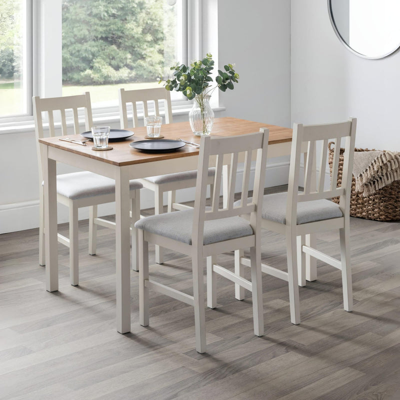 Dining room with a wooden table and chairs on a wooden floor.