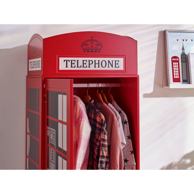 Red telephone box-shaped wardrobe with clothes inside, against a white wall.