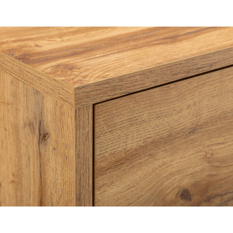 Close-up of a wooden drawer with a visible grain pattern