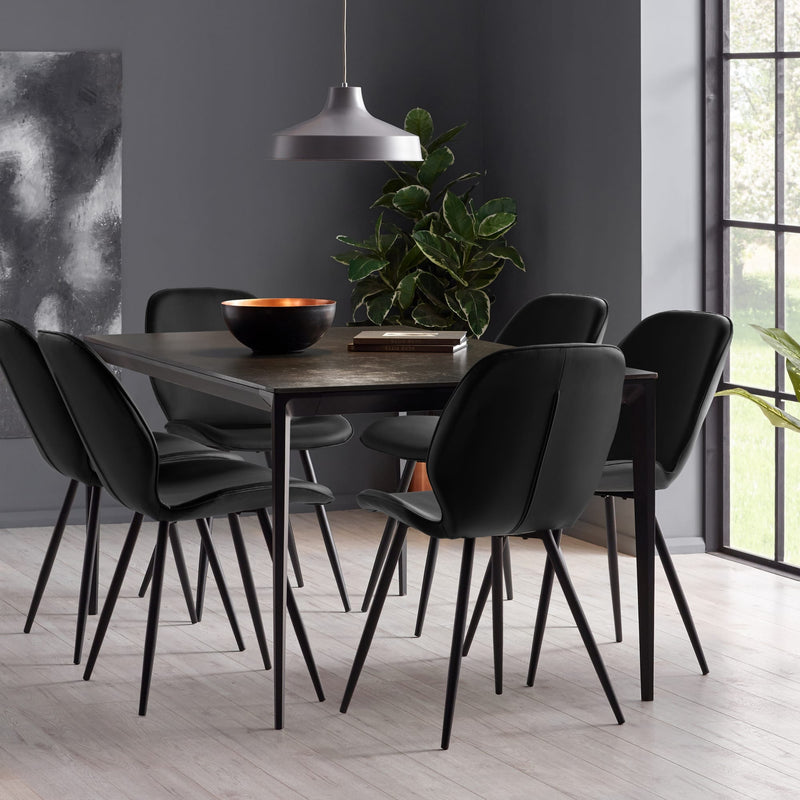 Dining room with a dark wooden table and black chairs in a modern setting.
