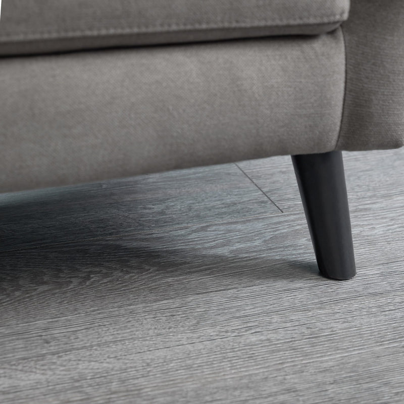 Gray sofa leg on a wooden floor