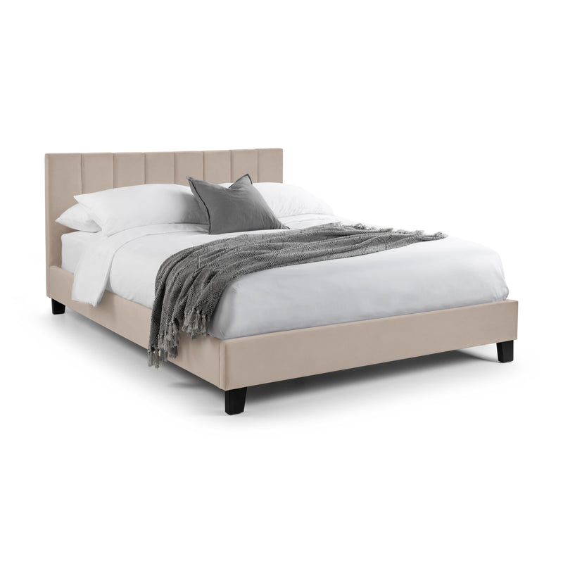Beige bed with white bedding and gray blanket on a white background