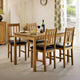 Dining room with wooden table and chairs, wine glasses, and a bottle.