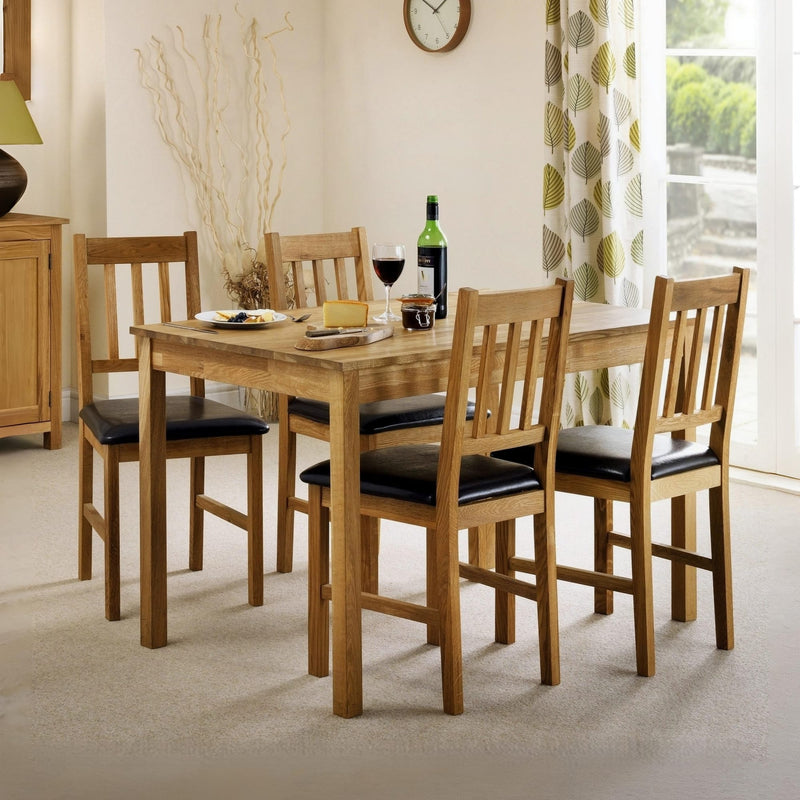 Dining room with wooden table and chairs, wine glasses, and a bottle.