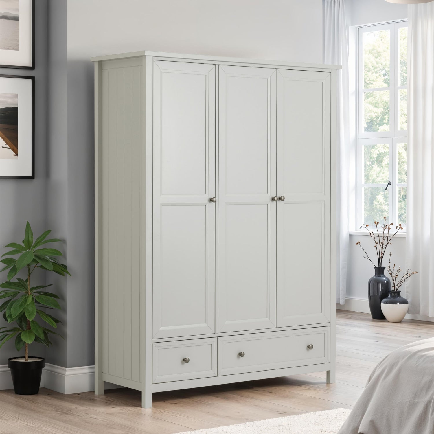 Gray wardrobe in a bedroom with a plant and window in the background