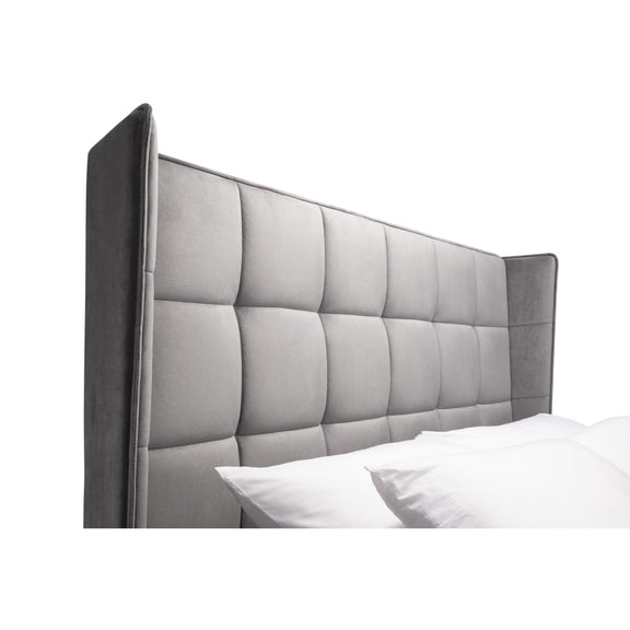 Gray upholstered headboard with tufted design on a white background