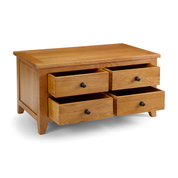 Wooden dresser with four drawers on a white background