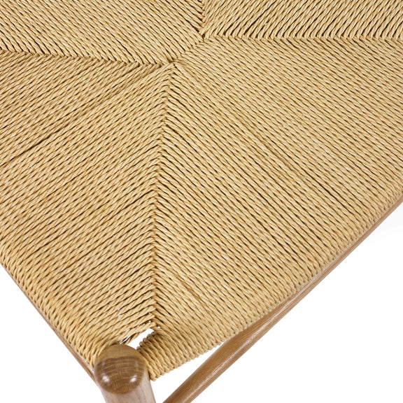 Close-up of a woven chair seat with a zigzag pattern on a white background