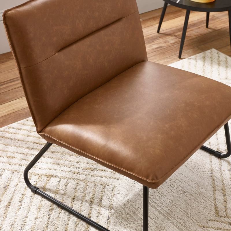 Brown leather chair with black metal legs on a textured rug