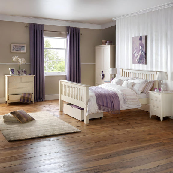 Neatly arranged bedroom with a bed, dresser, and window with curtains.