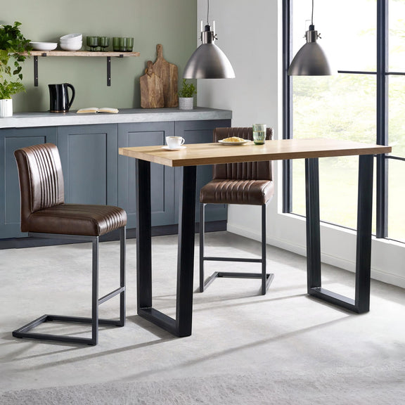 Modern kitchen with a wooden dining table and brown bar stools.