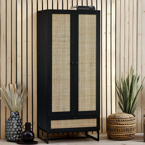 Black cabinet with woven doors in a room with plants and decor