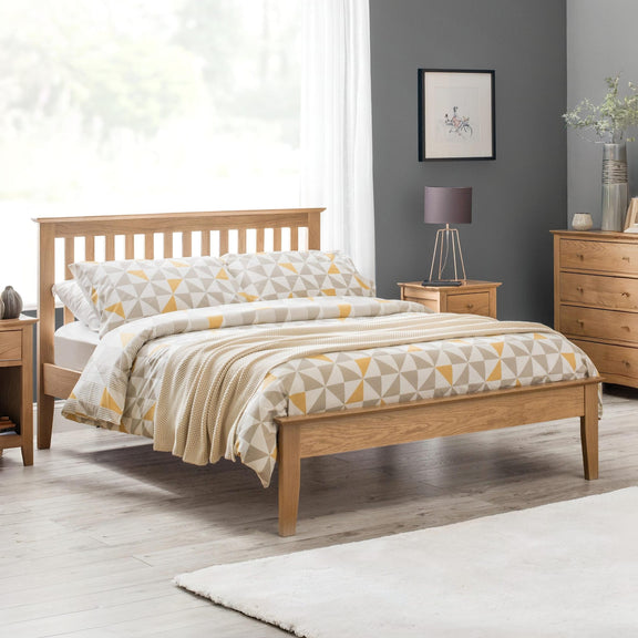 Bedroom with wooden bed, nightstands, and a lamp.