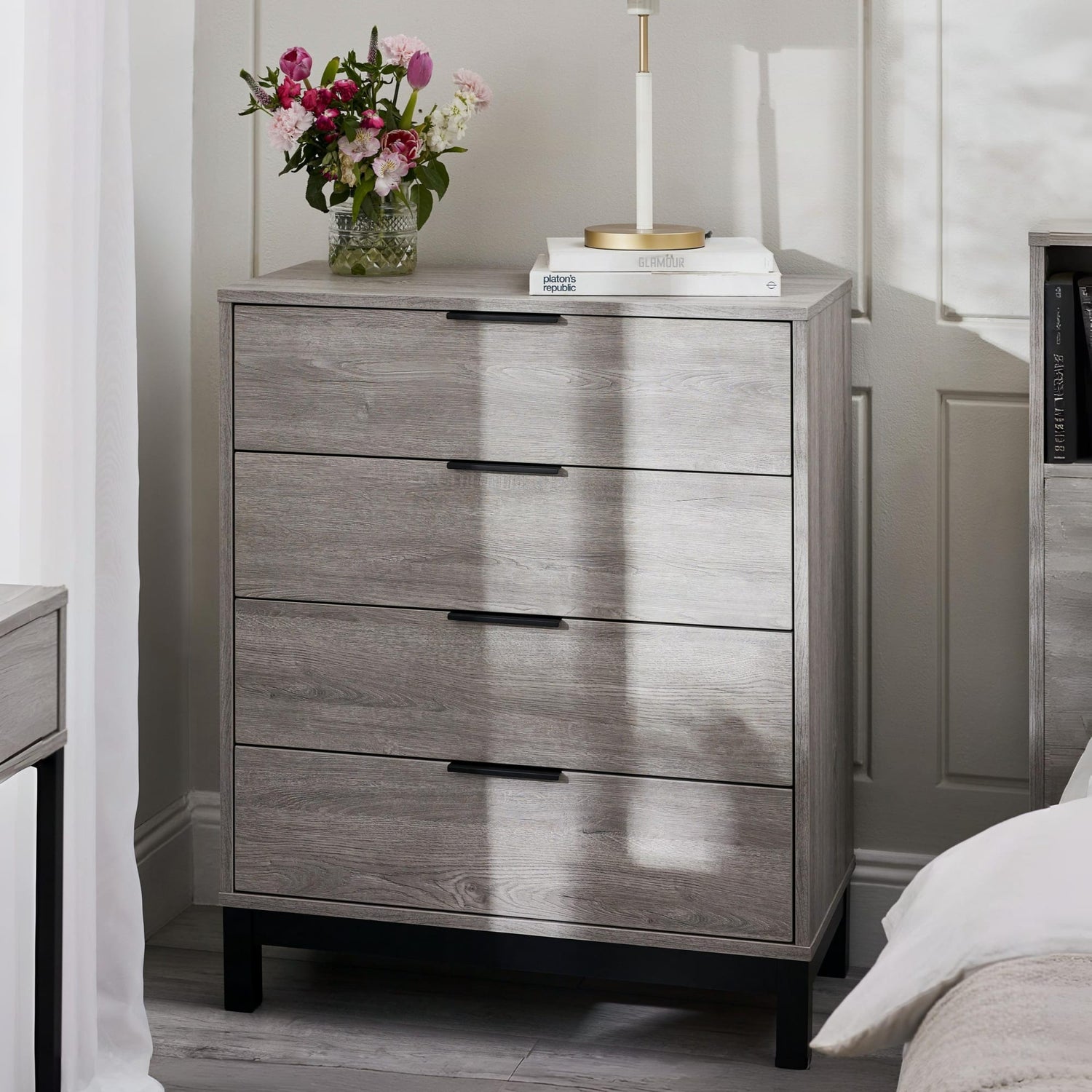 Wooden dresser with three drawers in a bedroom setting