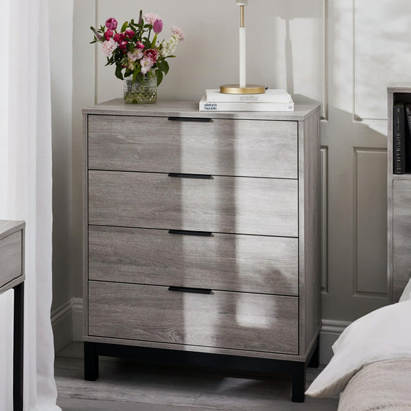Wooden dresser with three drawers in a bedroom setting