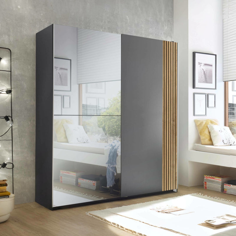 Modern wardrobe with glass panels in a bedroom setting