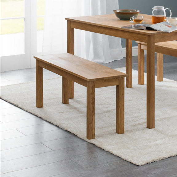 Wooden dining table with bench in a bright room