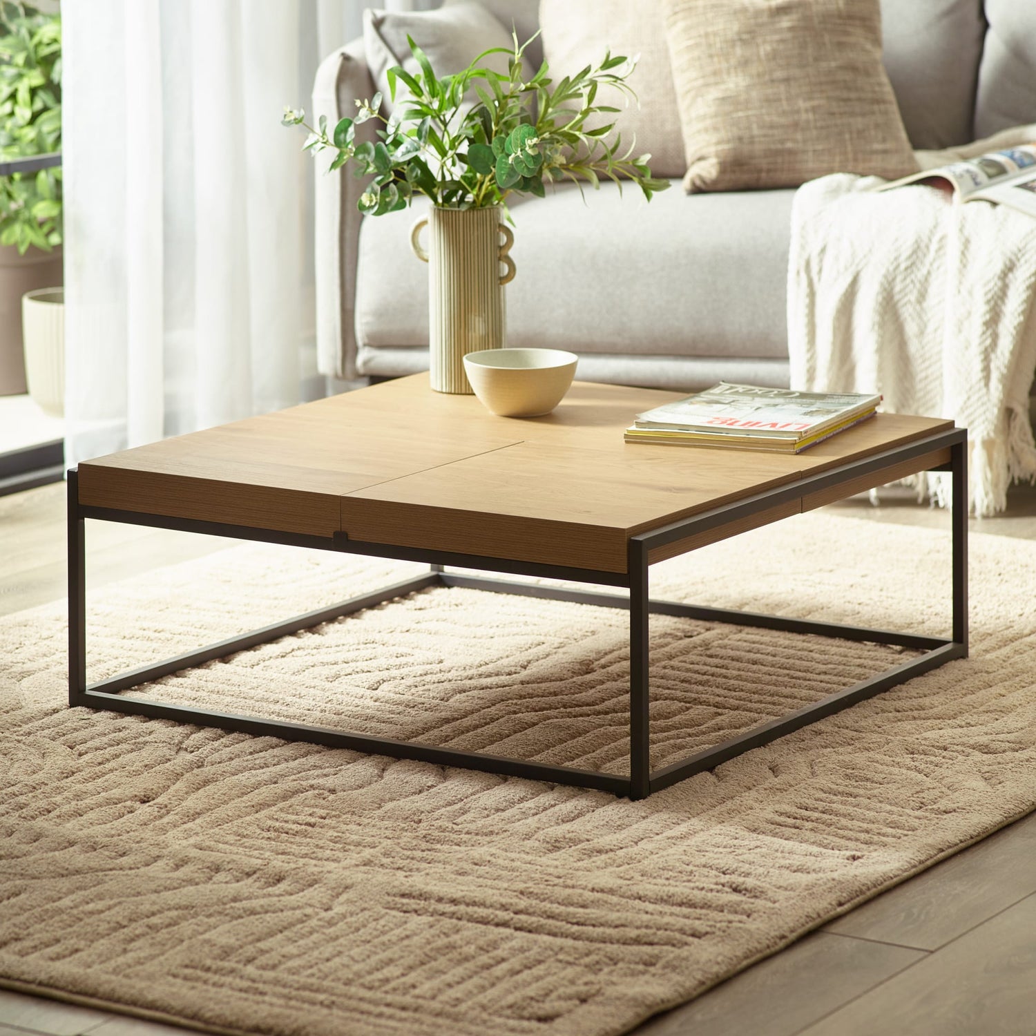 Wooden coffee table with decorative items in a living room setting